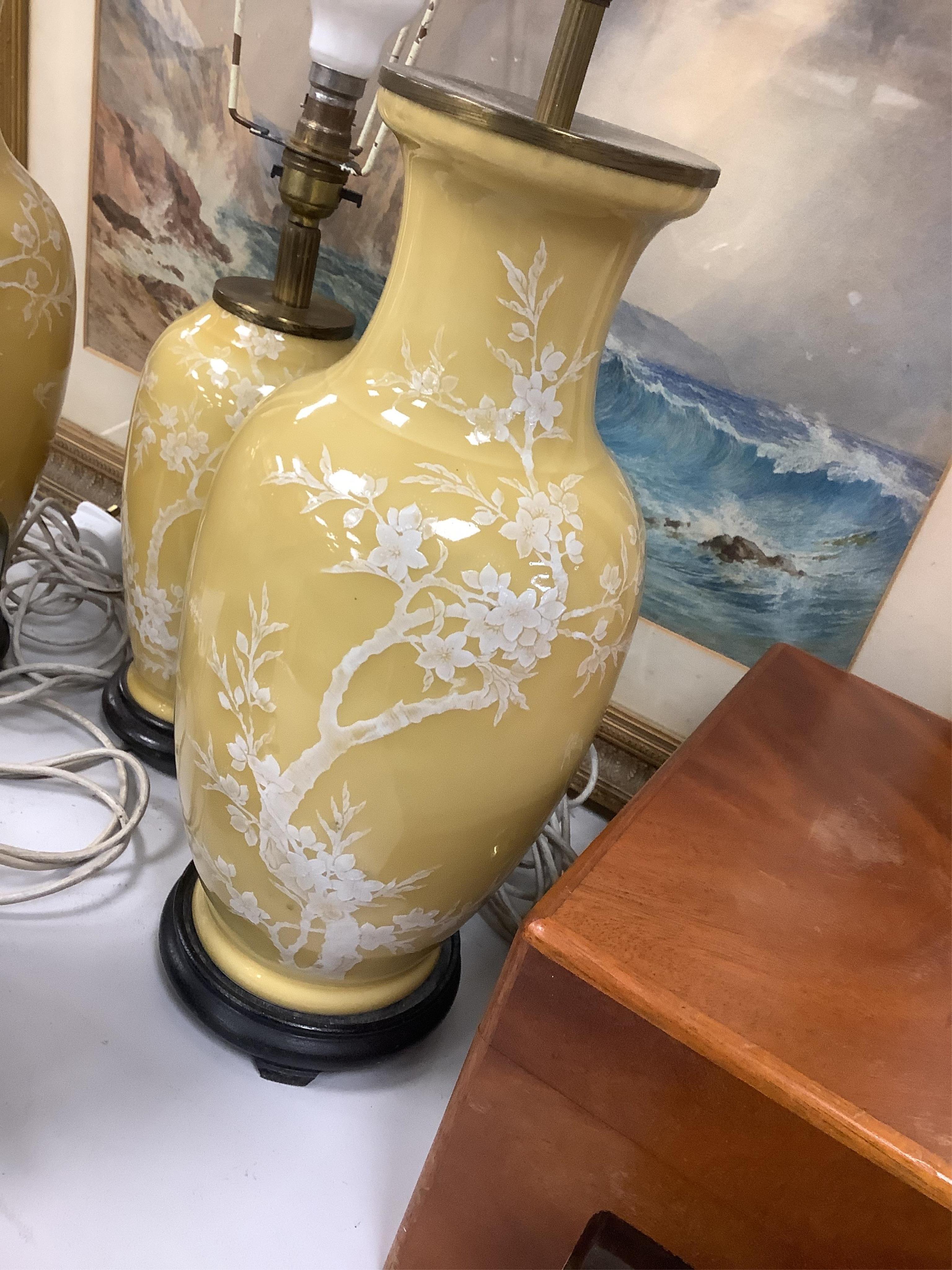 A garniture of three Chinese yellow ground lamp bases, pair 40cm high. Condition - fair